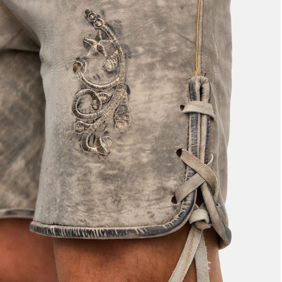Thigh embroidery view of model wearing rustic grey Oktoberfest lederhosen